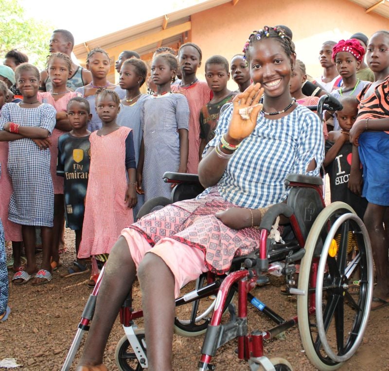 Tata, 14, celebrates getting a new wheelchair from ChildFund after her family lost their possessions in a fire.