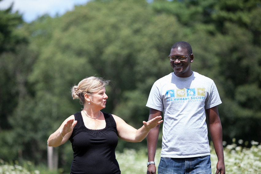 Debbie Gautreau of Northborough, MA takes her guest Momodou M. Bah of the Gambia for a walk in the woods near her house on August 8, 2015.