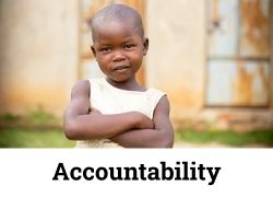Confident young child with arms crossed, representing accountability and resilience.